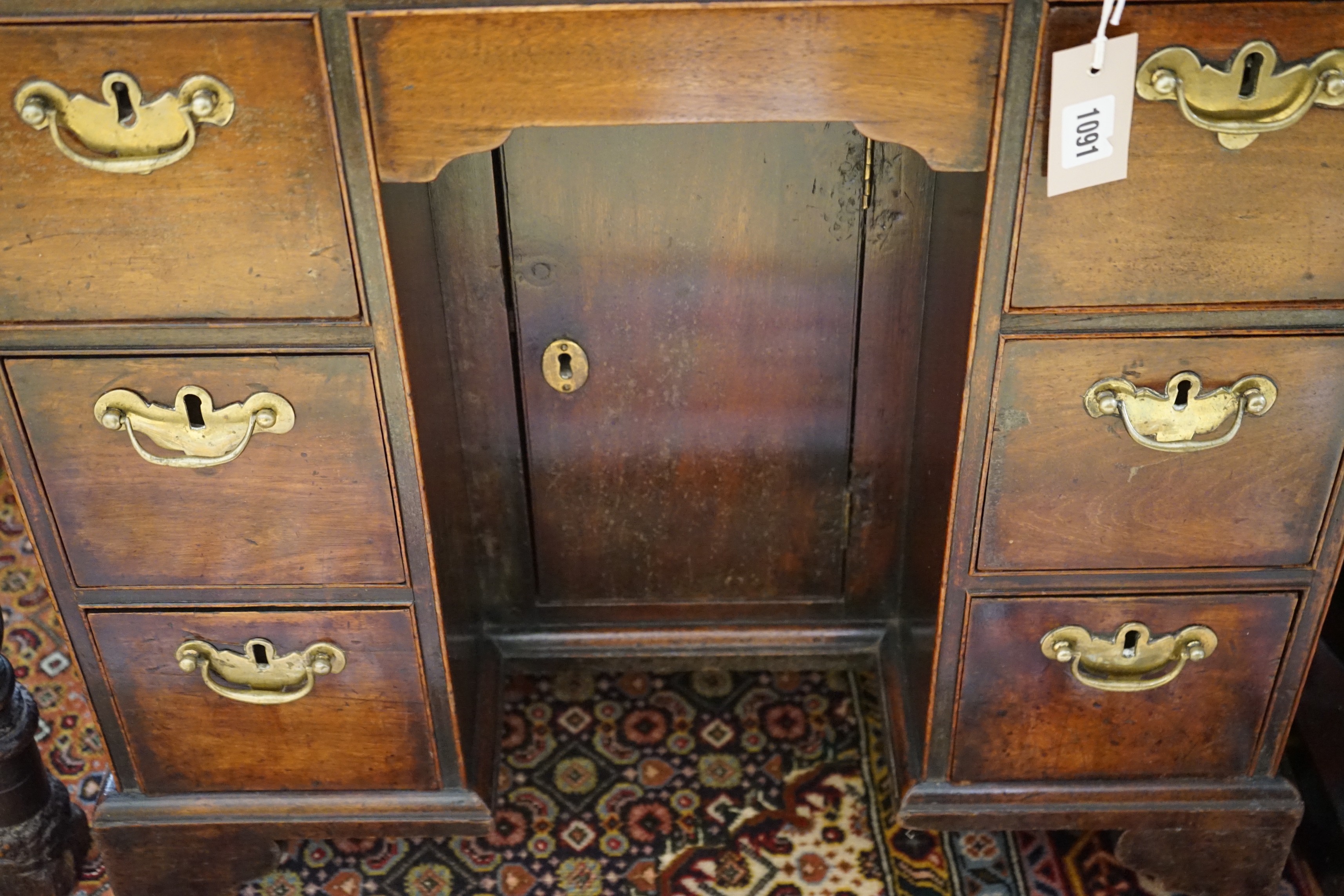 A small 18th century and later mahogany kneehole desk, width 68cm, depth 41cm, height 74cm